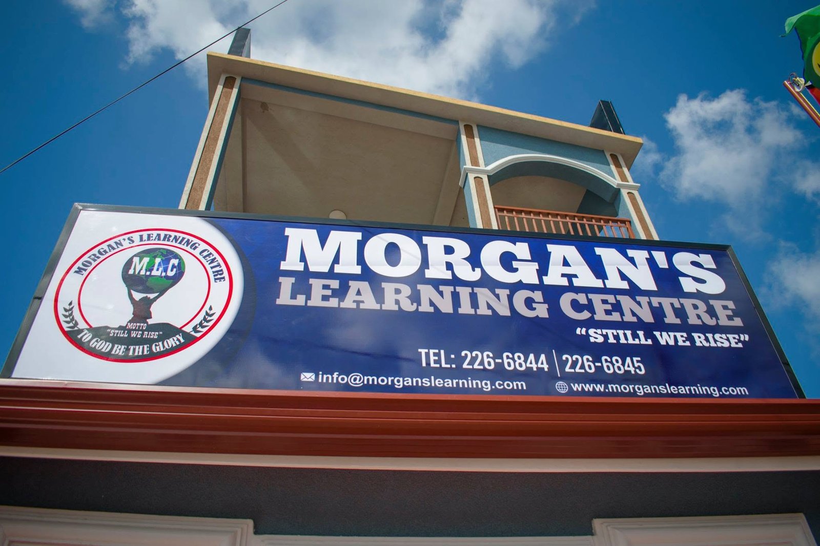 Morgan’s Learning Centre sign beneath a blue and cream building, with no people visible